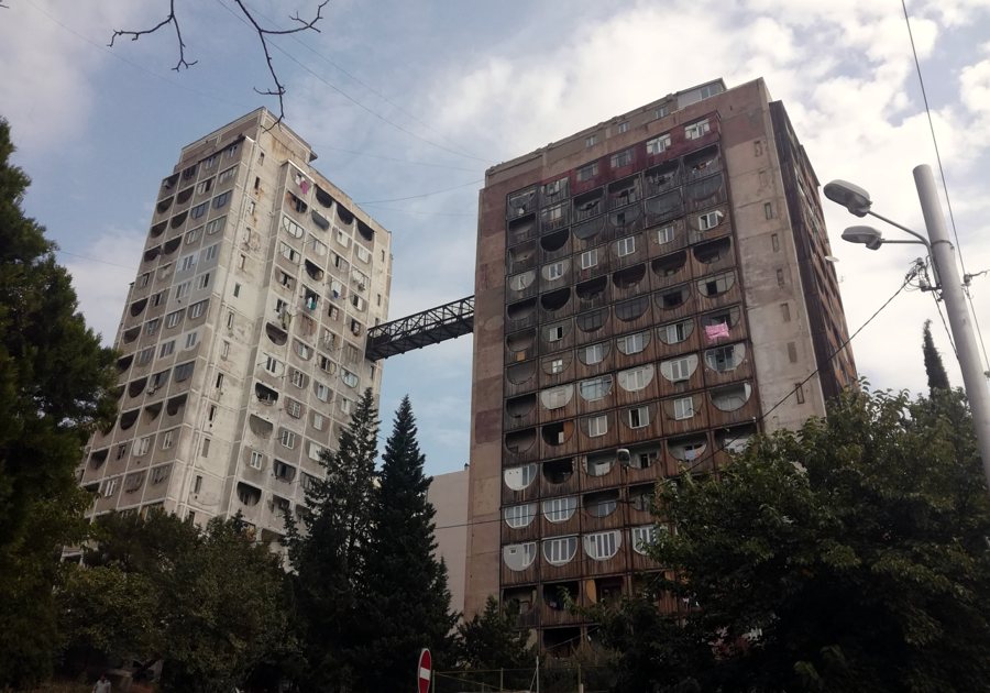 Two high-rise residential blocks connected by a bridge